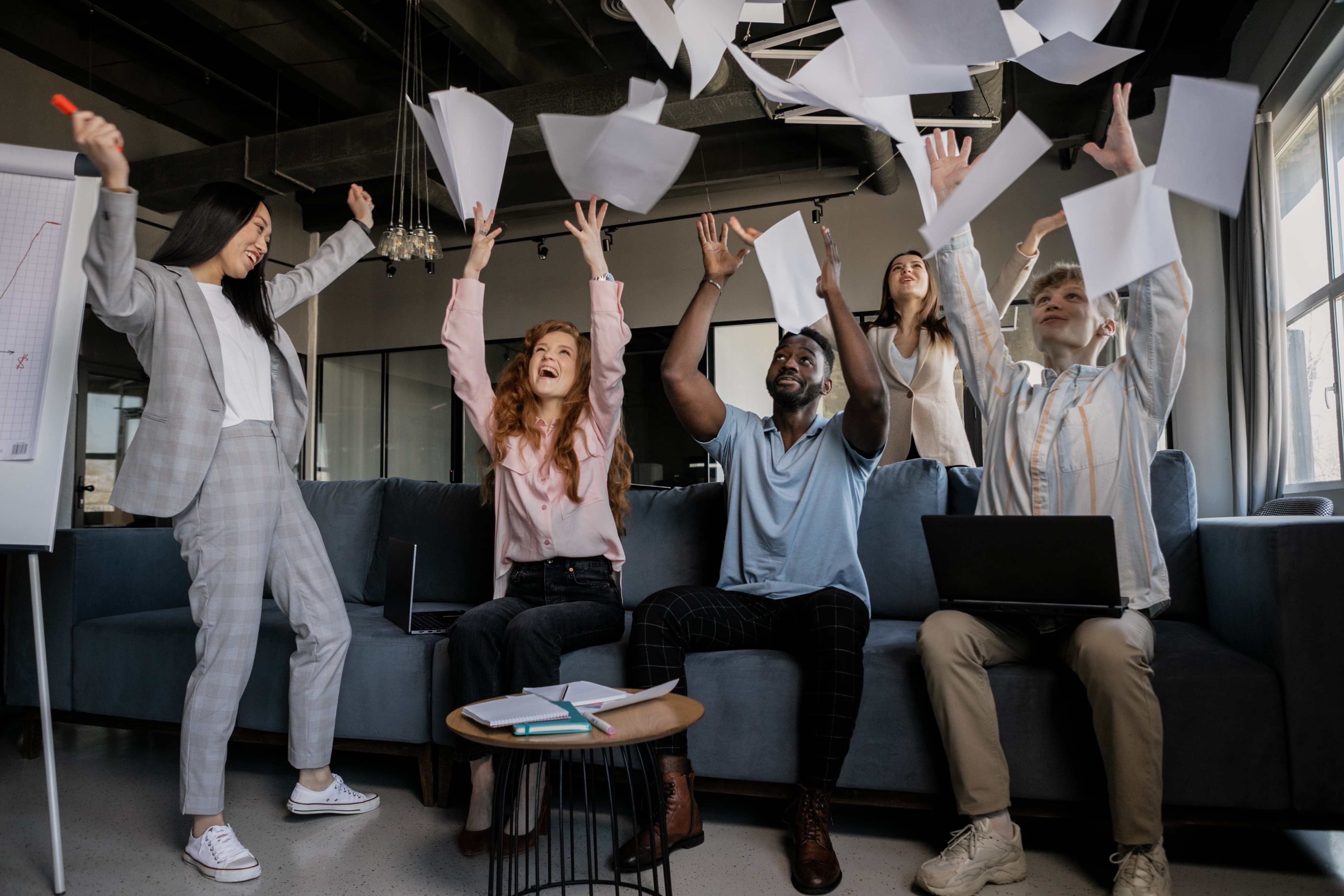 Image of 5 team members celebrating business wins.