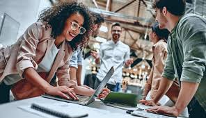 Image of a business owner and her team looking at QuickBooks Online.